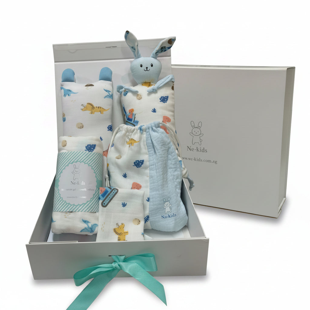 A baby gift set in a white box featuring a plush blue bunny toy, patterned swaddle blankets, and a packaged item with a teal ribbon, alongside the branded Ne-kids box lid in the background.